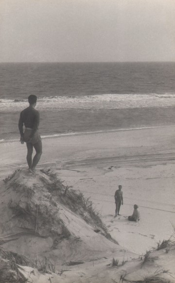 PaJaMa, Jos&eacute; Martinez, Paul Cadmus, &amp; Fidelma Cadmus, Fire Island, ​1939. Male figure in a swimsuit stands on top of a sand dune, back to the camera, looking down towards two figures at the bottom of the dune.