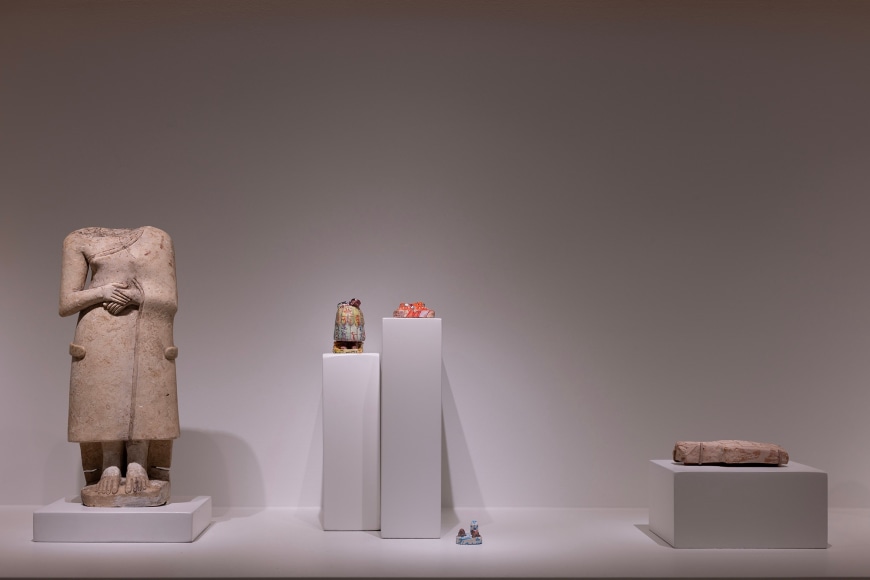 Left to right, Standing female figure with clasped hands