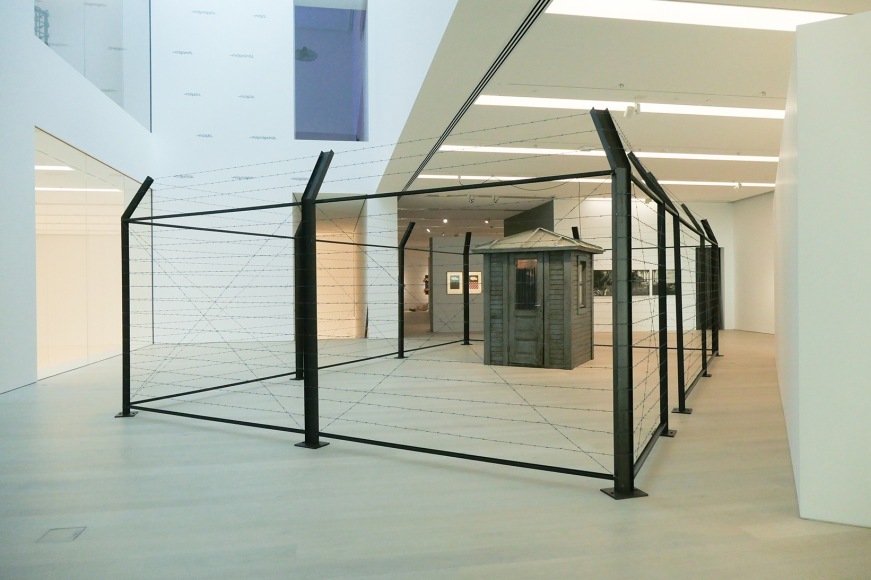 Hale Tenger,&nbsp;We didn&#039;t go outside; We were always on the outside/ We didn&#039;t go inside; We were always on the inside, 1995, Guard house found on site, barbed wire, pocket radio,, tea cup, fat, etc. and audio, 1400 x 600 x 240 cm