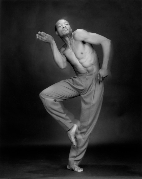 Bill T. Jones dancing, one foot in the air.