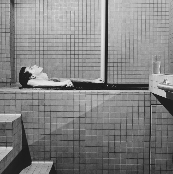 James Ford in profile, lying in bathtub.