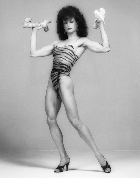 Lisa Lyon in leotard flexing arms