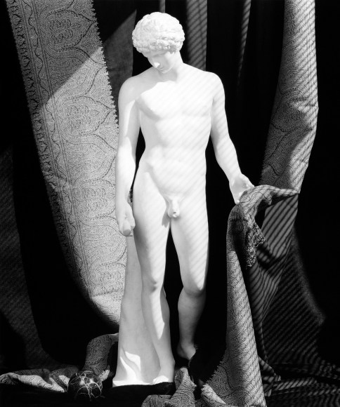 Sculpture of Antinous against a curtain background