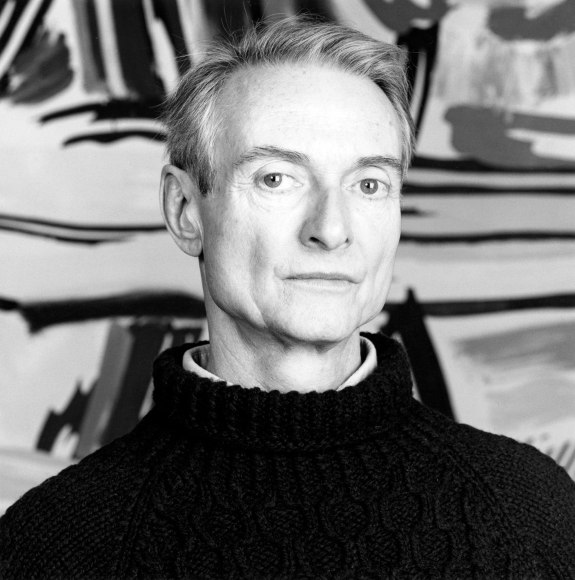 Portrait of Roy Lichtenstein in front of painting.