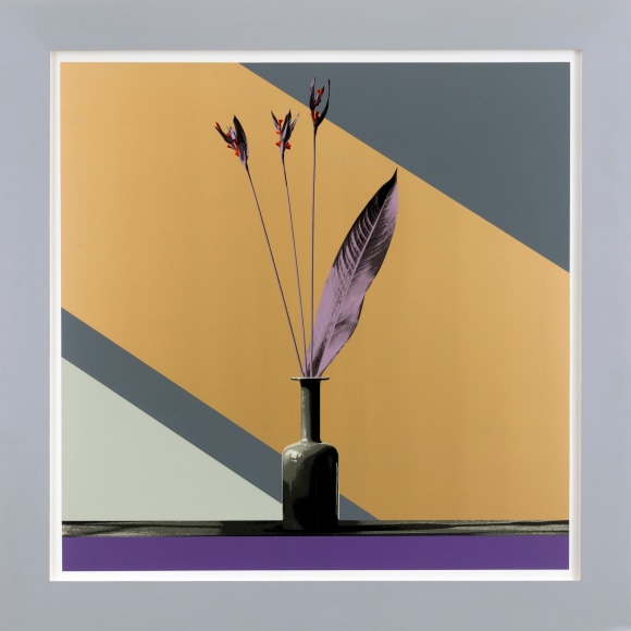 Three branches in a vase, with one large leaf in color.