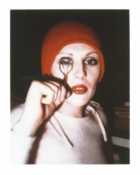 Candy Darling using eyelash curler.