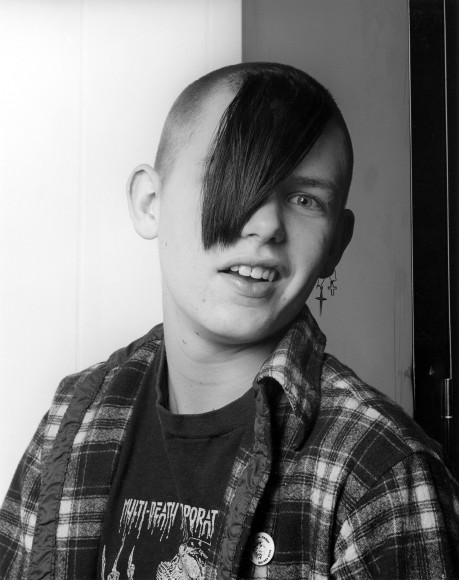 White male facing the camera, hair covering one eye.