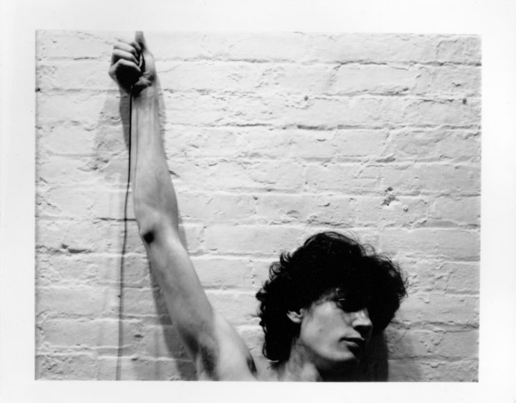 Self-Portrait against brick wall.