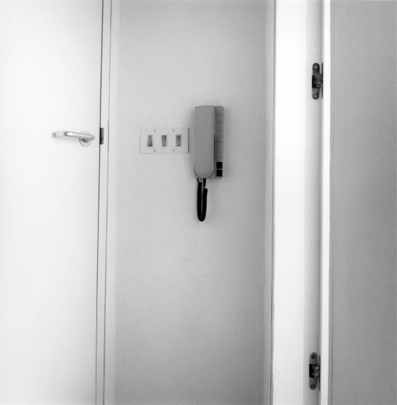 Interior of room, light switch and phone visible.