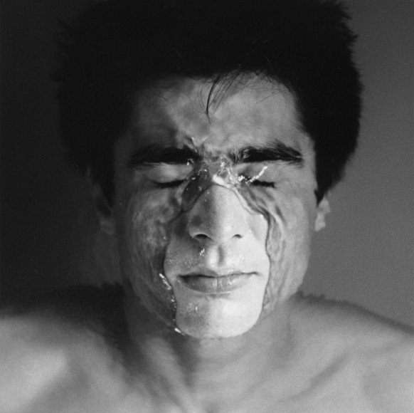 Javier's face and shoulders, face partially submerged in water.