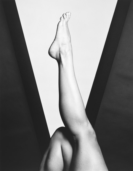 Lisa Lyon's leg extending upwards against geometric background.