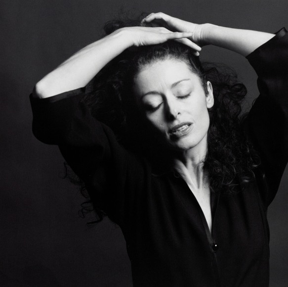 Portrait of Lynn Davis with her hands in her hair.