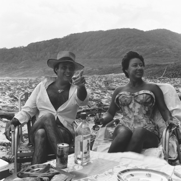 Princess Margaret and a man looking towards the right, on a beach.
