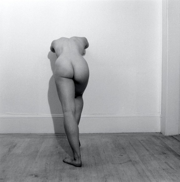 Lisa Lyon with her back to the camera, bent over so her head is not visible