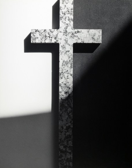 Cross with light shining on it.