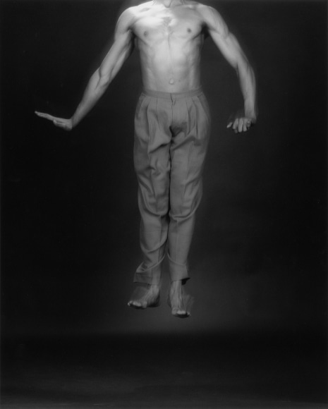 Bill T. Jones jumping, with head outside of the frame.