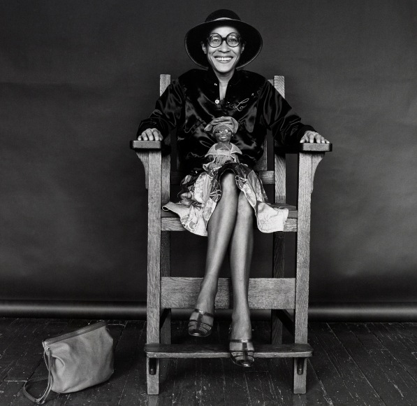 Dorothy Dean sitting in a large chair smiling at the camera.