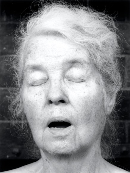 Alice Neel with eyes closed and mouth open.