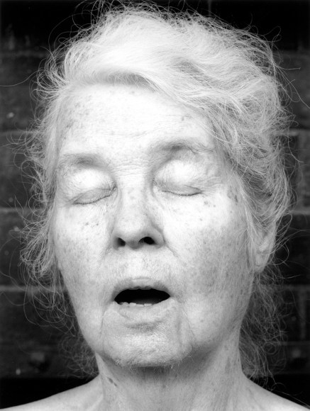 Alice Neel with eyes closed and mouth open.