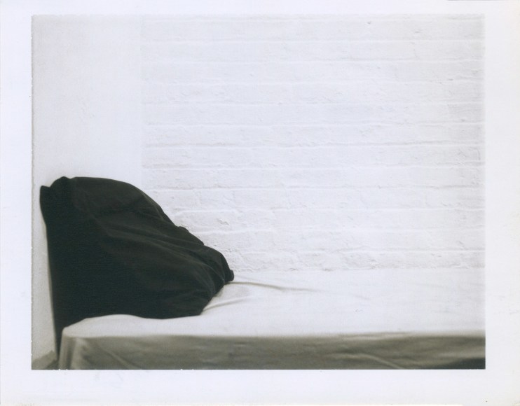 Interior shot of a pillow on a bed.