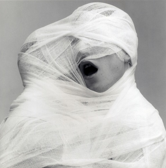 Two people wrapped together in white gauze.