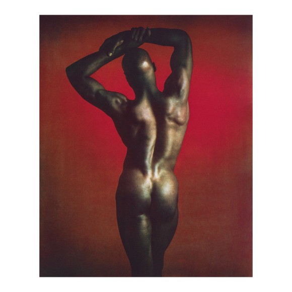 Ken Moody, naked, facing away from camera with arms stretched over head.