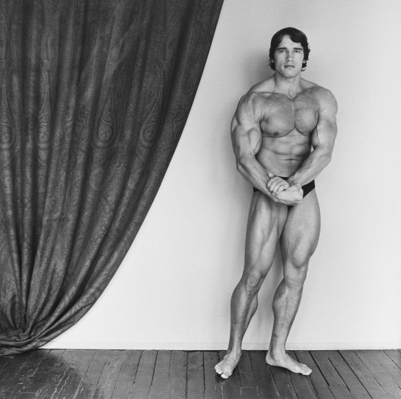Arnold Schwarzenegger flexing and posing