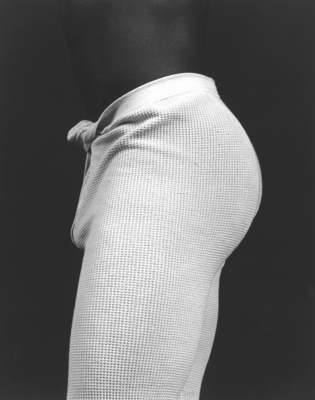 Black male in profile, waist to knees, in thermal pants.