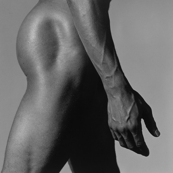 Nude black man from the side.