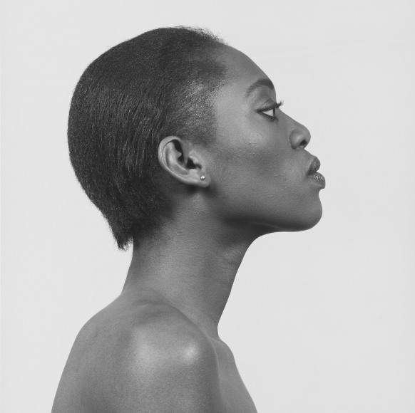 Profile portrait of a topless woman from the shoulders up.