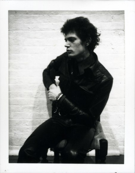 Self-Portrait of the artist sitting on a chair.