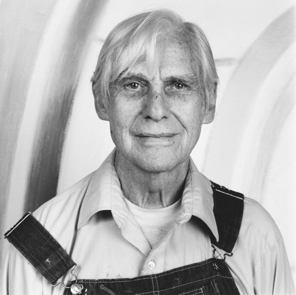 Portrait of the artist in overalls.