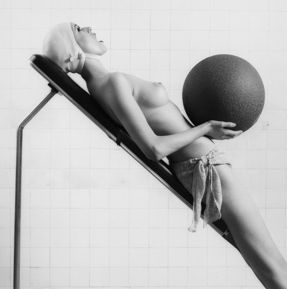 Woman leaning back and holding ball for fashion magazine
