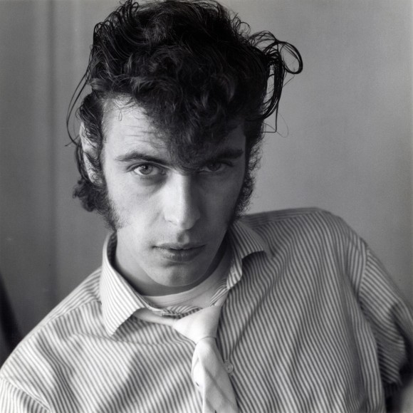 White man in shirt and tie staring directly into camera.