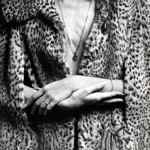 Jennifer Jakobson wearing leopard coat, with manicured hands held in center.