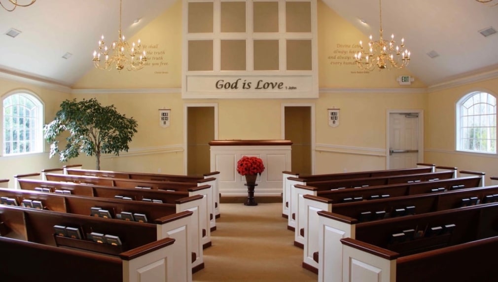 Interior of a Christian Science church with the inscription &quot;God is Love&quot;