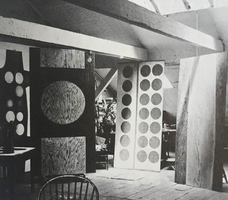 One Golden Orb (1959/2001),&nbsp;&nbsp;Twenty-one Golden Orbs (1959/2001), and&nbsp;Slip (1959) in Indiana&#039;s studio at 25 Coenties Slip, July 1959. All three paintings are seen in early states