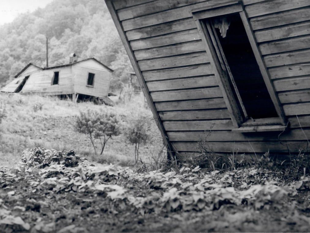 Two houses appear to lean in opposite directions.