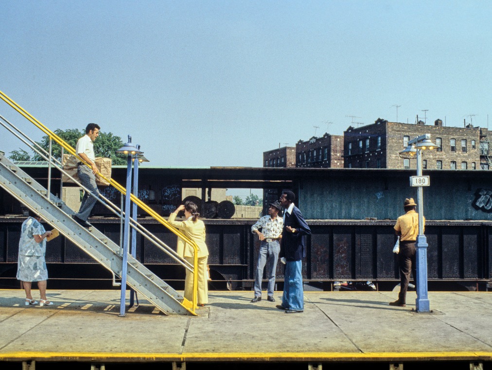 A blue and yellow scene shows people waiting for the Subway.