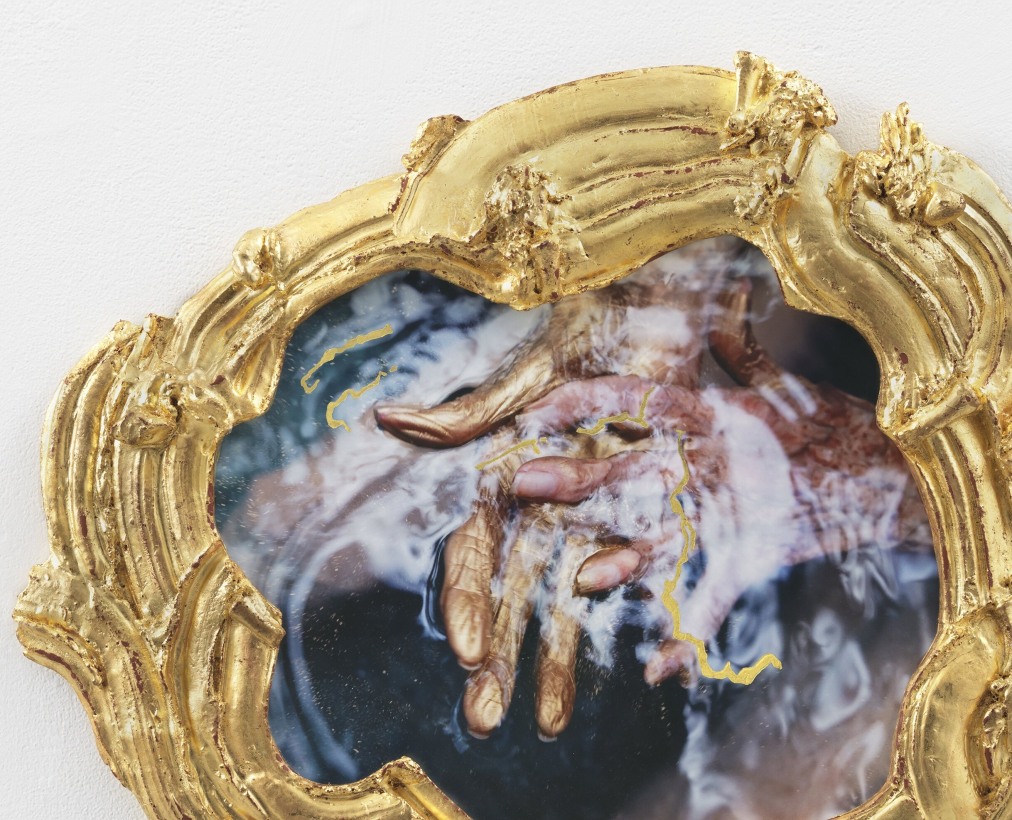 Alt="Janine Antoni, My waters rest, 2019, Mixed media gilded with 24 karat gold leaf, praying hands above blue water"