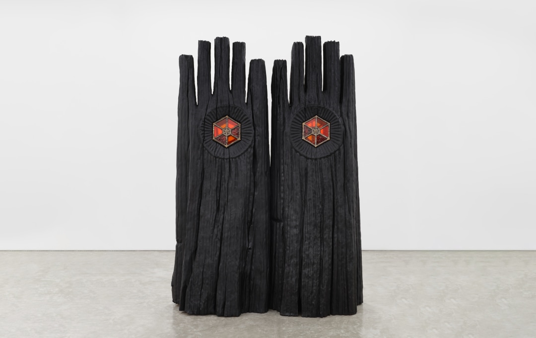 Detail of a tall wooden sculpture by Dan John Anderson