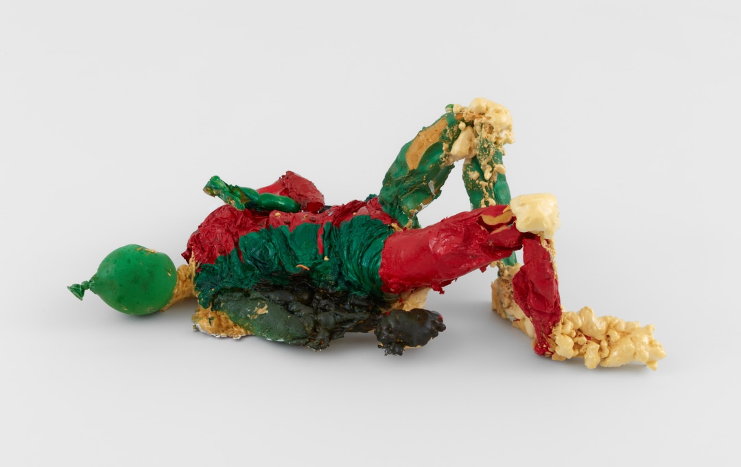 Green, red, and yellow figurative sculpture by Samara Golden made of expanding spray foam, acrylic paint, rubber balloons, and nylon tights.