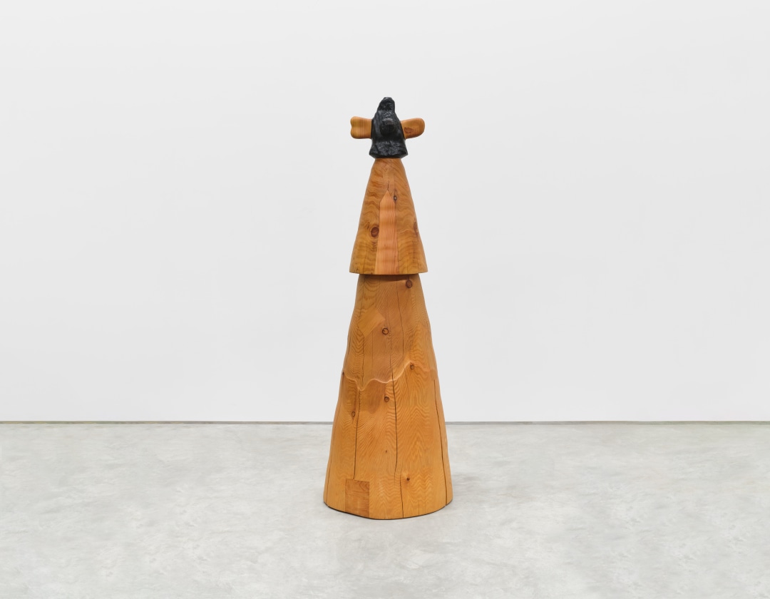 A totemic wooden sculpture with three tiers of interlocking and smoothly sanded wood.