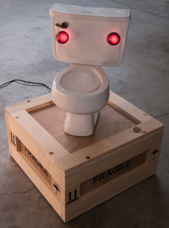 Untitled Cast ceramic toilet, permanently sealed wood crate (contents: Vintage artwork by Jon Pylypchuk with packaging), light bulbs, wiring and hardware.