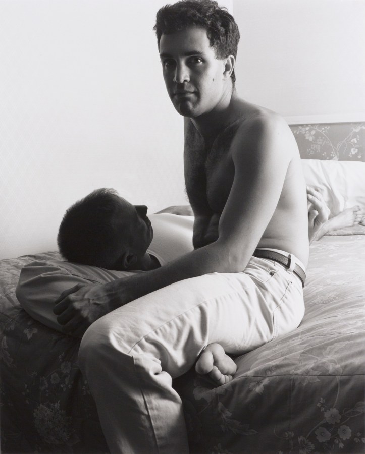 Two men on hotel bed by Stephen Barker
