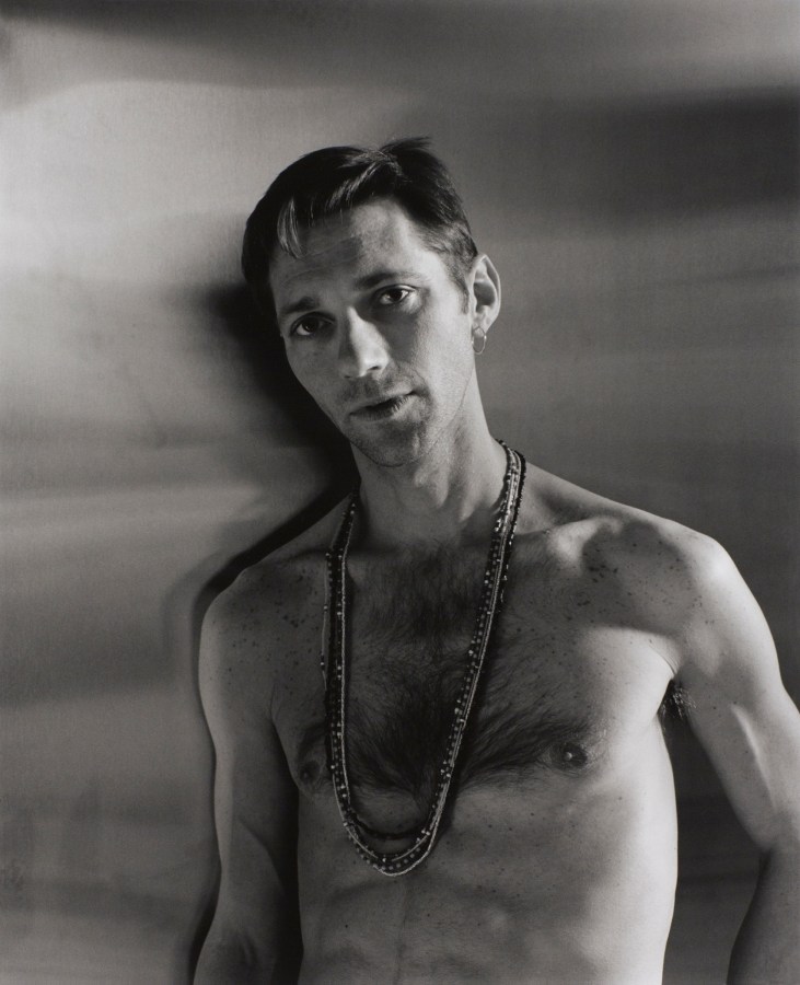 Man with beaded necklace by Stephen Barker