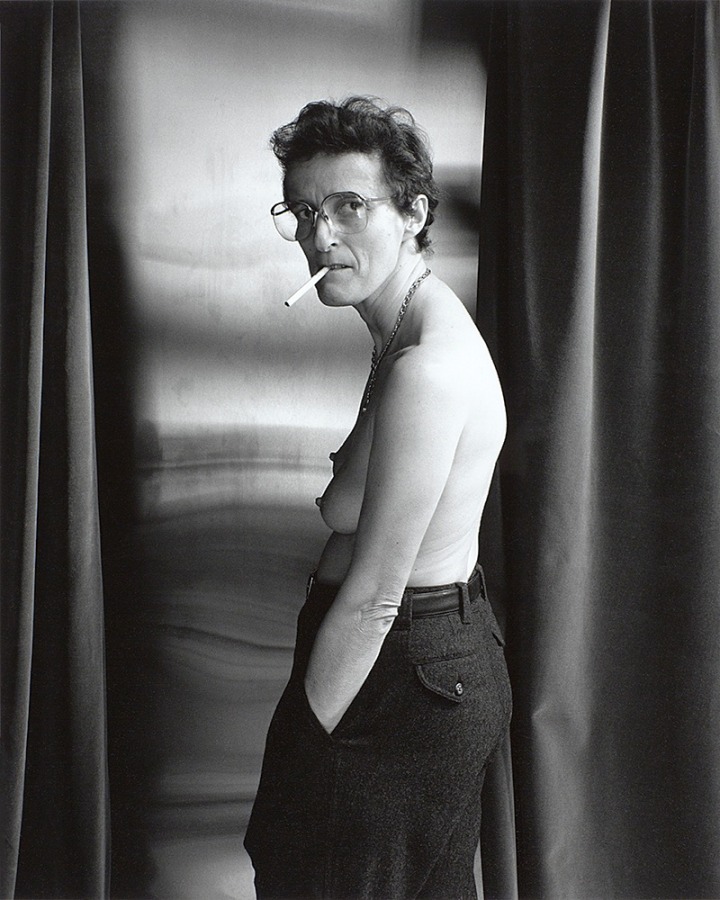 Topless woman smoking by Stephen Barker