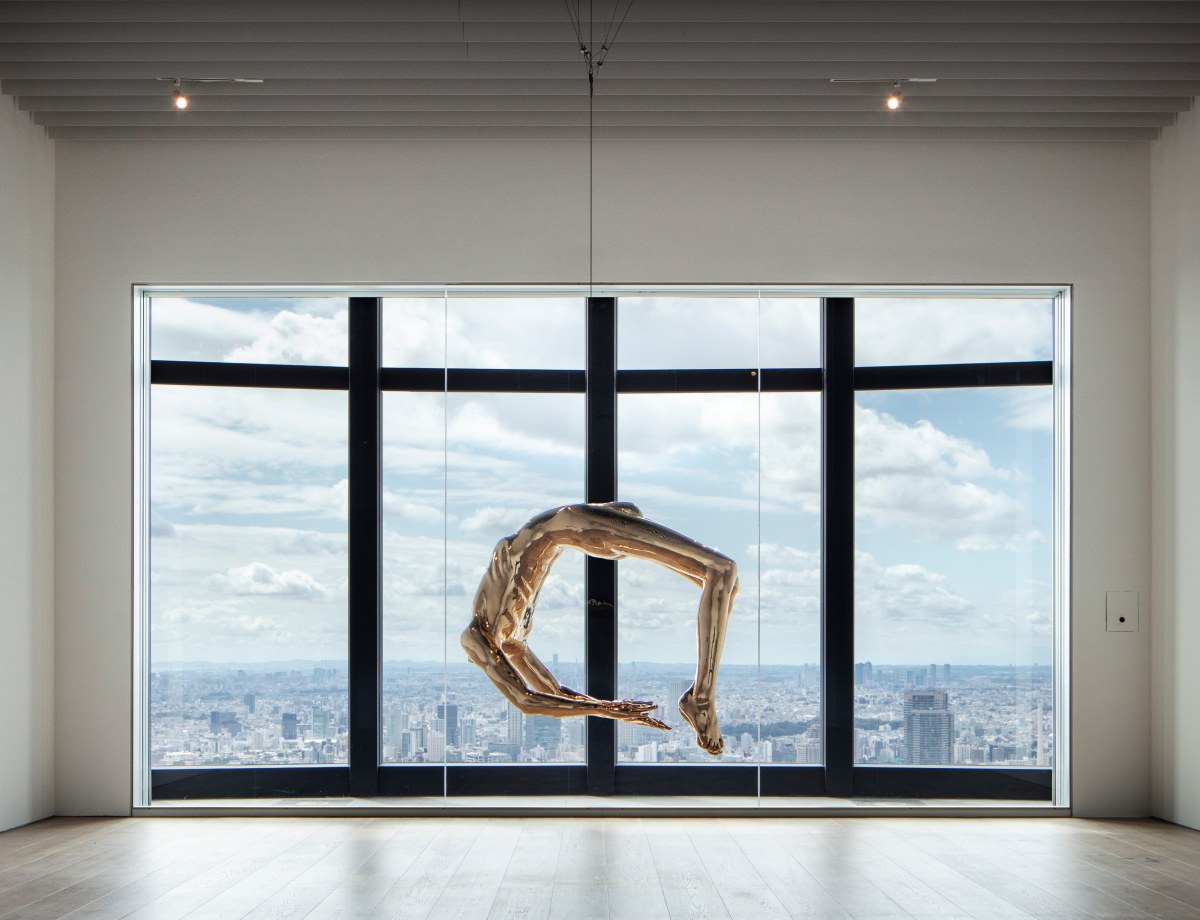 Installation view of "Arch of Hysteria" by Louise Bourgeois, at the Mori Art Museum. The Tokyo cityscape is visible through the window that frames the artwork.