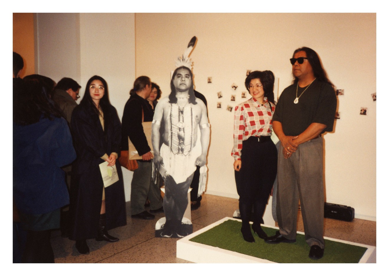 Take a Picture with a Real Indian, 1991, Chromogenic silver gelatin, and Polaroid prints, nails, wood, artificial turf, tripod, Polaroid camera, Polaroid film, tape recorder, audio cassette, sound, vinyl text, and chairs