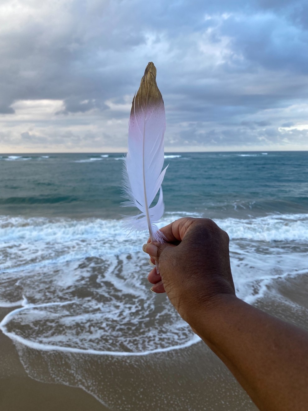 Photo by Xenobia Bailey of untitled private deliverance ceremony on Atlantic Ocean at low tide, 2023